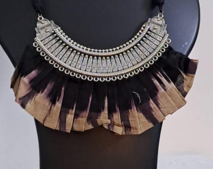 Exclusive necklace with silver oxidised big oval pendant with fabric fringes and matching earrings.