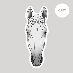 May include: A sticker featuring a stylized illustration of a horse's head. The horse is depicted in shades of gray and white, with black outlines. The word "GREY" is in a white circle in the upper right corner. The background is a light gray.