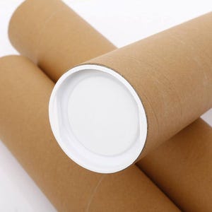 May include: Close-up of several brown cardboard mailing tubes with white plastic end caps. The tubes are cylindrical and designed for shipping posters, prints, or other rolled items. The end caps provide a secure closure.