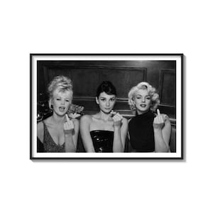 May include: Black and white framed print featuring three iconic actresses: Sophia Loren, Audrey Hepburn, and Marilyn Monroe. Each is giving the middle finger. The image is a classic, vintage-style photograph.