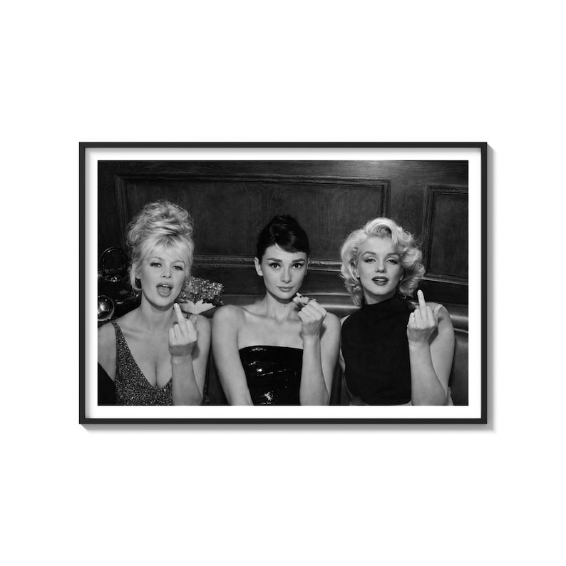 May include: Black and white framed print featuring three iconic actresses: Sophia Loren, Audrey Hepburn, and Marilyn Monroe. Each is giving the middle finger. The image is a classic, vintage-style photograph.