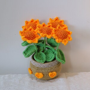 Knitted sunflower pots, each with 5 knitted sunflowers on top, the sunflowers are removable and can be pulled off the pots