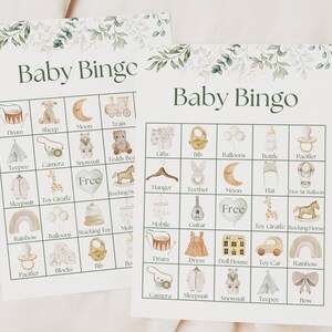 May include: Two printable baby bingo cards with a green floral border. The cards feature illustrations of baby items such as a pacifier, a rattle, a rocking horse, a teddy bear, a teepee, a camera, a snowsuit, a hat, a bottle, a bib, a dress, a dollhouse, a toy car, a rainbow, a drum, a guitar, a mobile, a moon, a stacking toy, a toy giraffe, a pair of blocks, a bib, a bow, and a pair of shoes. The cards are free to download and print.