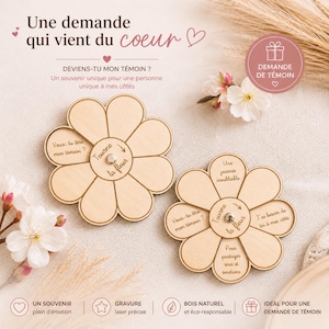 Op de afbeelding: Twee houten bloemvormige aandenkens met gegraveerde tekst, waaronder "Veux-tu être mon témoin?" en "Tourne la fleur". Het ontwerp heeft een centraal draai-element. De afbeelding bevat ook de tekst "Une demande qui vient du coeur."