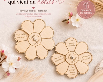 Peut inclure: Deux souvenirs en forme de fleur en bois avec des textes gravés, dont "Veux-tu être mon témoin ?" et "Tourne la fleur". Le design présente un élément central rotatif. L'image comprend également le texte "Une demande qui vient du coeur."