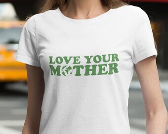 May include: A white t-shirt with a green graphic that says "LOVE YOUR MOTHER" with a green recycling symbol replacing the "O" in "MOTHER".