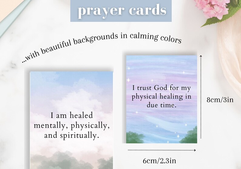 May include: Two prayer cards with watercolor backgrounds. The first card has a light blue, pink, and purple sky with a white cloud and the text "I am healed mentally, physically, and spiritually." The second card has a light blue, pink, and purple sky with stars and the text "I trust God for my physical healing in due time." The cards are 6 cm by 8 cm.