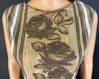 May include: A sleeveless dress featuring a brown and tan striped pattern with large brown rose floral designs. The dress has a scoop neckline and is displayed on a mannequin. The dress is a vintage style.