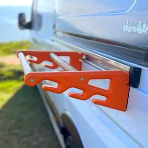 RailRack for Sprinter/Crafter - a drying rack for wetsuits and other gear. Connects to the side door rail of MB Sprinter and VW Crafter.