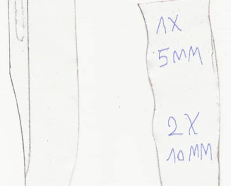 May include: A hand-drawn sketch of a knife blade and a label with measurements. The label indicates dimensions of 5mm and 10mm, with quantities of 1X and 2X. The knife blade is depicted in a simple, linear style.