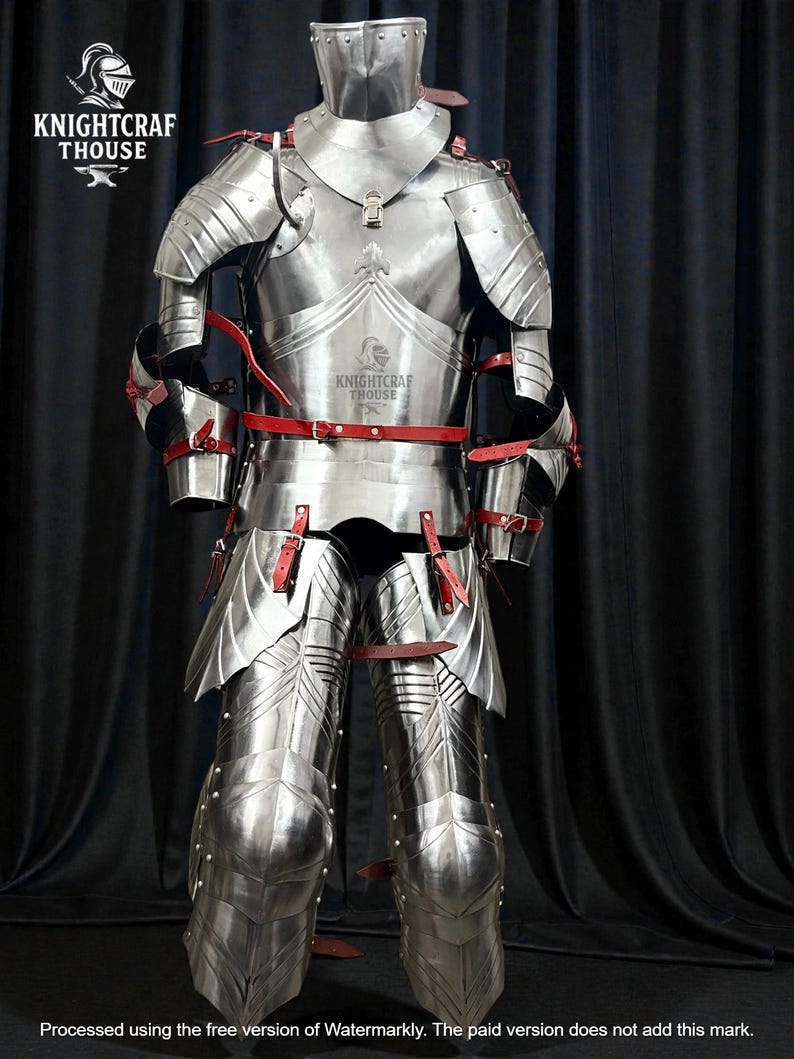 May include: A full suit of polished steel armor with red leather straps. The armor includes a helmet, chest plate, arm and leg protection. The Knightcrafthouse logo is visible on the chest plate. The armor is displayed against a dark background.