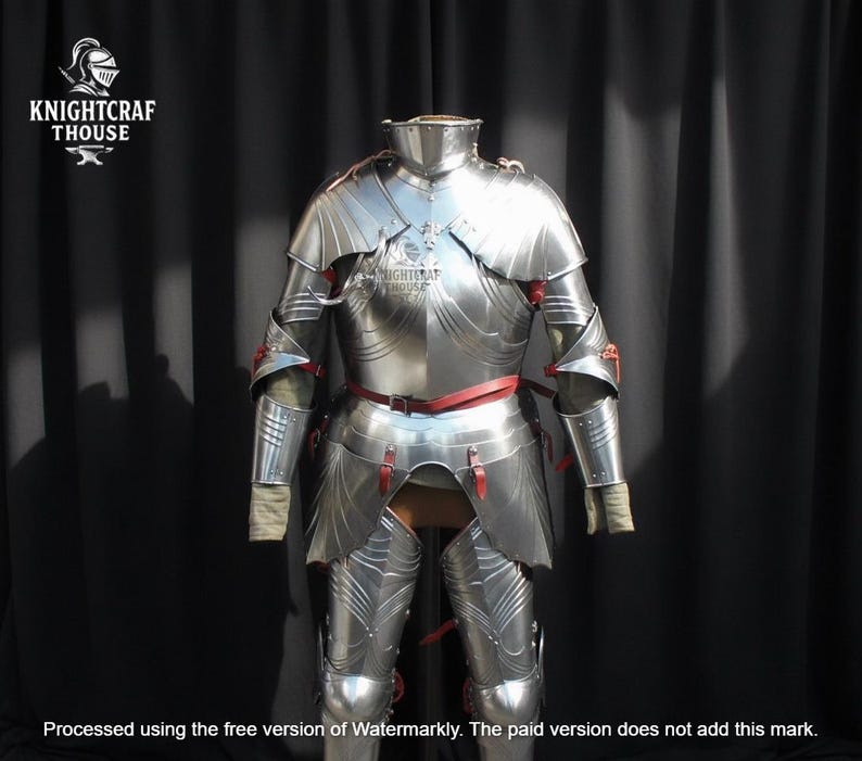 May include: A full suit of polished steel armor, featuring articulated plates for the arms, legs, and torso. The armor includes a gorget, pauldrons, and greaves, with red leather straps and accents. The Knightcrafthouse logo is visible.