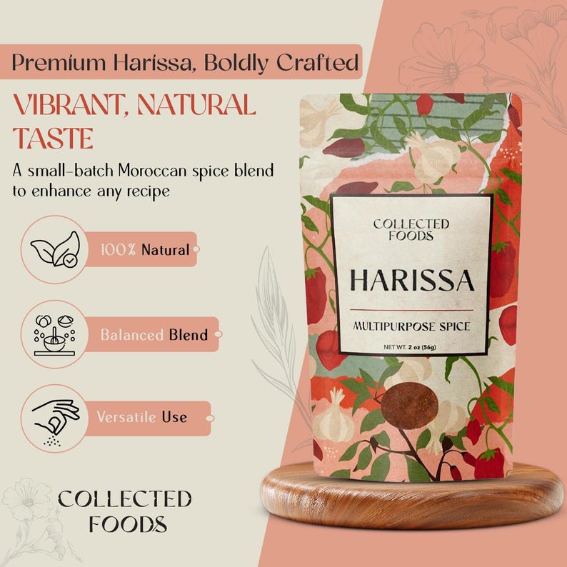 May include: A package of Collected Foods Harissa multipurpose spice, net weight 2 oz (56g). The package has a floral design with red peppers and white flowers. Text on the package reads "Harissa" and "Multipurpose Spice". The background is a light peach color.