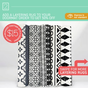May include: Five black and white patterned rugs with geometric designs. The rugs are stacked on top of each other. The text "Swipe for more layering rugs" is in red on a white background.