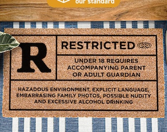 May include: A brown coir doormat with the text "RESTRICTED" in black. The doormat also has a large black "R" in the top left corner and the text "UNDER 18 REQUIRES ACCOMPANYING PARENT OR ADULT GUARDIAN" in black. The doormat also has the text "HAZARDOUS ENVIRONMENT, EXPLICIT LANGUAGE, EMBARRASING FAMILY PHOTOS, POSSIBLE NUDITY AND EXCESSIVE ALCOHOL DRINKING" in black. The doormat also has the text "Treated With DURAPRINT® Technology" in black.