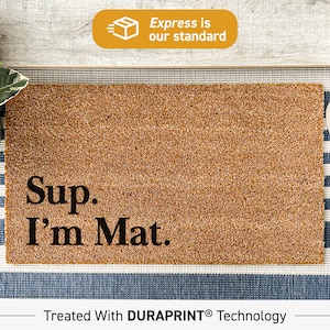 May include: A brown coir doormat with the text "Sup. I'm Mat." printed in black. The mat is treated with DURAPRINT technology.