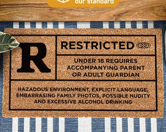 May include: A rectangular tan coir doormat with a black border and text. The left side features a large letter R. The right side reads RESTRICTED, UNDER 18 REQUIRES ACCOMPANYING PARENT OR ADULT GUARDIAN, HAZARDOUS ENVIRONMENT, EXPLICIT LANGUAGE, EMBARRASSING FAMILY PHOTOS, POSSIBLE NUDITY AND EXCESSIVE ALCOHOL DRINKING.