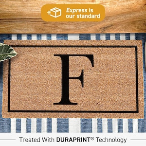May include: A rectangular tan coir doormat featuring a large black letter F centered within a thin black rectangular border. The mat has a coarse, natural fiber texture and is treated with DURAPRINT technology for a durable finish.