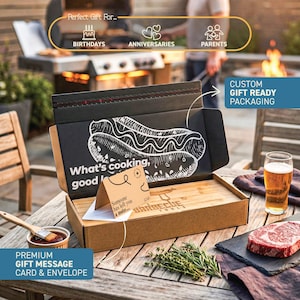 a gift box with a hot dog drawing on it, placed on a wooden table with a glass of beer and some herbs. The box is labeled as a "Perfect Gift For..." and includes a "Premium Gift Message Card & Envelope".