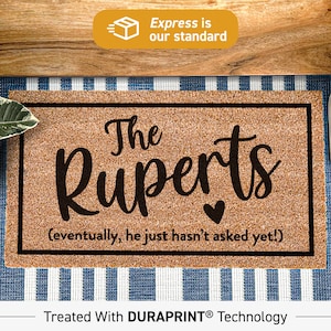 May include: A brown coir doormat with black text that reads "The Ruperts (eventually, he just hasn't asked yet!)". The doormat is treated with DURAPRINT® technology.