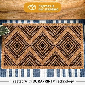 May include: A rectangular doormat with a geometric diamond pattern in black on a natural brown background. The mat is made of a coarse material and is placed on a blue and white striped surface. The text "Express is our standard" is in a yellow box.