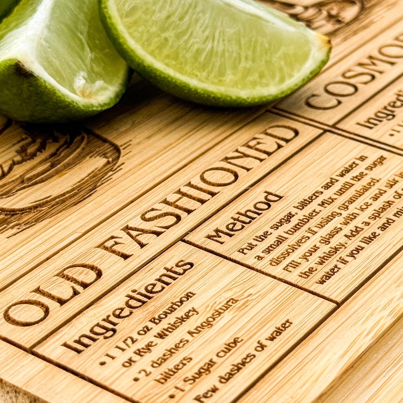 a close up of a cutting board with limes on it