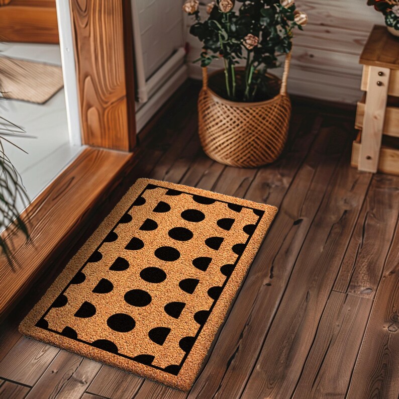 a door mat on a wooden floor next to a potted plant