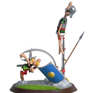 Op de afbeelding: Gedetailleerd beeldje dat een scène uit een stripverhaal uitbeeldt. Eén personage valt aan, terwijl een ander aan een paal hangt. De basis is bruin met groen gras. Een blauw schild staat in het midden.