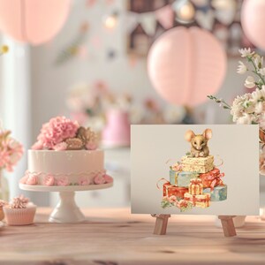 May include: A cute brown mouse sits on top of a stack of wrapped gifts. The gifts are wrapped in blue, red, and green paper with white ribbons. The gifts are on a white background.