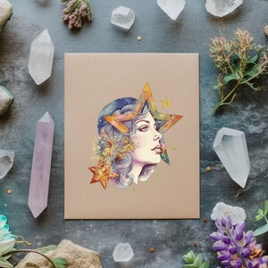 May include: A watercolor illustration of a woman's face with a large star behind her head. The star is made up of different colors and has a gold outline. The woman's hair is blue and purple and she has a soft, dreamy expression.