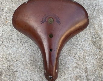 Vintage french leather bicycle saddle. Stamped to each side "Henri Gauthier2" and Goudron Véritable on the top.