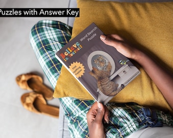 May include: A person is reading a book titled "Believe in Yourself" with a word search puzzle. The book cover features a tiger looking in a mirror and a bluebird perched on a table. The book has a yellow star with the text "Five Uplifting Puzzles".