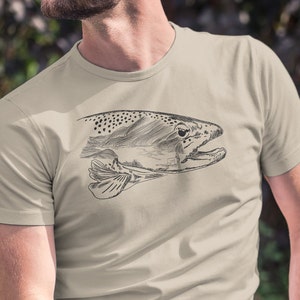 May include: A beige t-shirt featuring a black and white line drawing of a trout fish on the front.