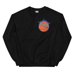 May include: Black sweatshirt with a basketball graphic featuring the New York City skyline and the text "NEW YORK" in orange and blue.