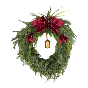 May include: A Christmas wreath featuring dense green foliage, adorned with a large burgundy velvet bow and smaller bows. A small gold bell hangs in the centre, adding festive charm. Ideal for seasonal decoration.