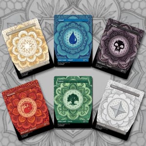May include: Six rectangular trading cards featuring intricate mandala patterns in yellow, blue, purple, red, green, and gray. Each card displays a central symbol representing Plains, Island, Swamp, Mountain, Forest, or Wastes, with text labels.