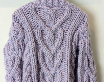 May include: A lavender cable knit sweater with a chunky knit texture.