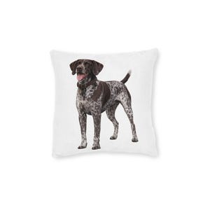 May include: A decorative throw pillow featuring a German Shorthaired Pointer dog. The dog has a brown head and patches on its body, with a white background. The dog is wearing a brown collar and has its tongue out.