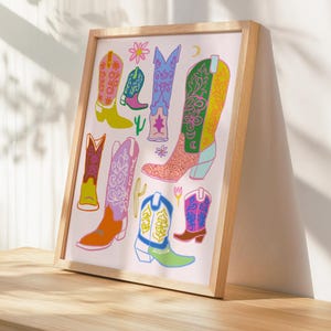 May include: A pink background with a collection of colorful cowboy boots with floral and geometric patterns. The boots are in various styles and colors, including pink, blue, yellow, green, and orange.