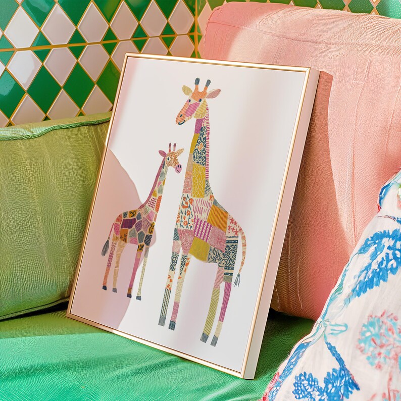 May include: A framed art print featuring two giraffes with patchwork patterns in various colors. The giraffes are set against a white background with a soft pink accent. The frame is gold-colored, adding a touch of elegance to the artwork.
