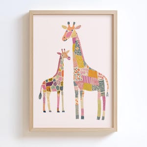 May include: A framed art print featuring two giraffes with patchwork-style patterns in various colors, including pink, yellow, and purple. The giraffes are set against a light pink background, and the frame is a light wood color. The artwork is suitable for a nursery or children's room.