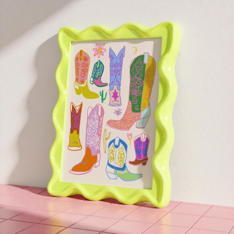 May include: A framed print with a colorful illustration of cowboy boots. The boots are decorated with floral patterns and have different colors, including pink, blue, green, yellow, and orange.