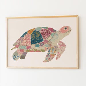 May include: A framed art print featuring a colorful sea turtle. The turtle's shell is composed of various patterned patches in shades of blue, pink, yellow, and green. The turtle has a pink head and is set against a cream-colored background.