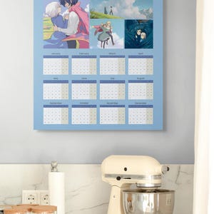 May include: A 2026 calendar featuring anime-style artwork. The calendar has a light blue background with images and dates for each month. The top of the calendar has the number "2026" and several anime-style illustrations.