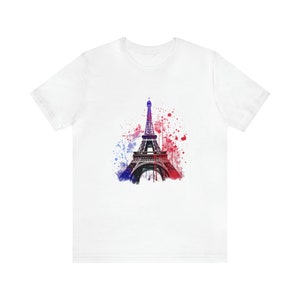 Op de afbeelding: Wit T-shirt met een aquarel-illustratie van de Eiffeltoren in tinten blauw, rood en wit.