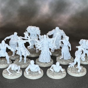 May include: A collection of light gray miniature fantasy figures, including warriors, wizards, and creatures. The figures are standing on circular bases with a stone texture, and are arranged in a group. The details of the figures are intricate.