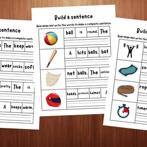 May include: Three educational worksheets titled Build a sentence, featuring rows of colourful illustrations including trousers, socks, a dress, a jacket, a ball, a bat, a net, a helmet, a weightlifter, a mat, a rope, and a timer with scrambled words to rearrange.
