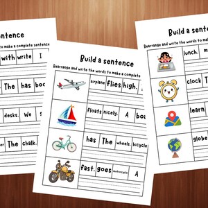 May include: Three educational worksheets titled Build a sentence with black text and colourful illustrations. Each sheet features rows of words in boxes next to images of objects like a book, desk, aeroplane, boat, bicycle, motorcycle, clock, and globe.