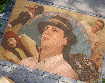 May include: A doormat with a retro design featuring a man wearing a hat and the text "I think you should leave". The doormat has a light brown background with blue and red accents.