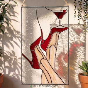 May include: A rectangular stained glass panel featuring a design of legs in red high-heeled shoes and a martini glass. The glass has a textured, rain-drop pattern throughout. The text glassgarden.net is printed at the bottom of the panel.